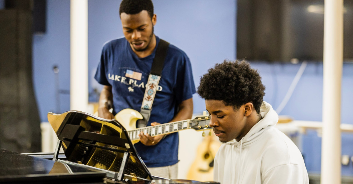 Two students playing instruments in a band.